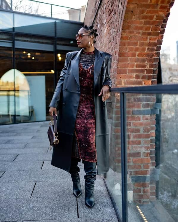 Fashionable African Maerican woman wears a leather black jacket over a dress and thigh high boots - Fashion Police Nigeria