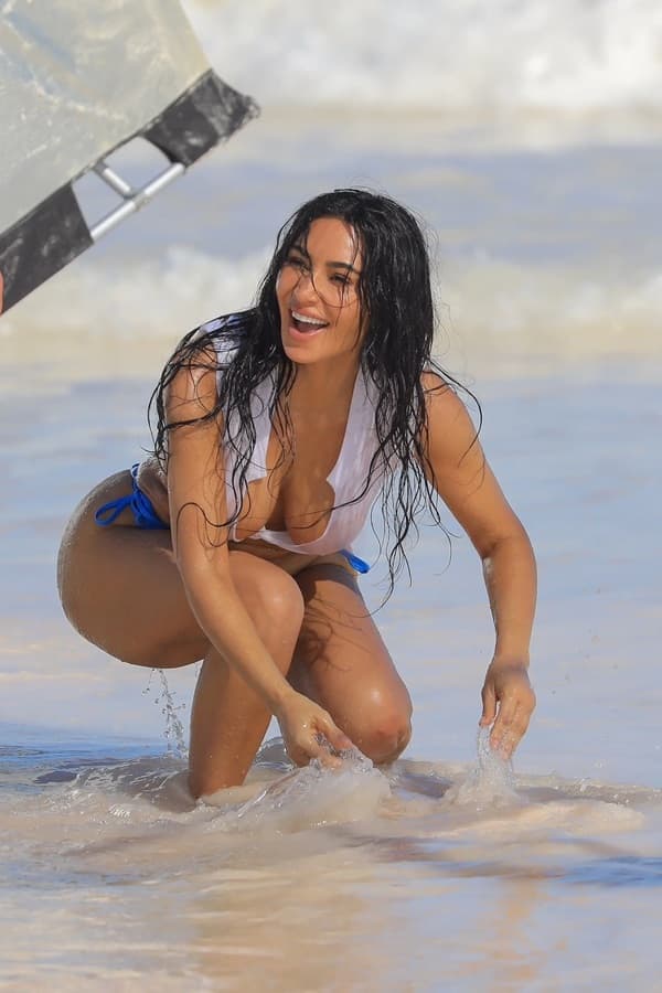 Kim Kardashian Wears a Mismatched White and Blue Bikini Set for a Beach Photoshoot