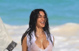 Kim Kardashian Wears a Mismatched White and Blue Bikini Set for a Beach Photoshoot
