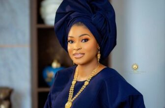 Nigerian bride wears a navy blue traditional wedding dress with coral beads - Fashion Police Nigeria