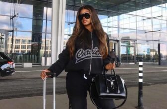 Photo of a fashion black woman wearing sweat shirt and pants at the airport - Fashion Police Nigeria