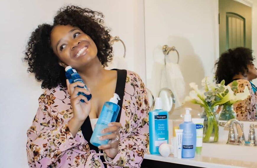 African American woman holding her skin care products for a photo selfie - Fashion Police Nigeria