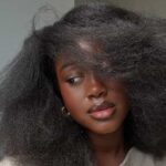 Black African woman wearing her strengthened, curly hair - Fashion Police Nigeria