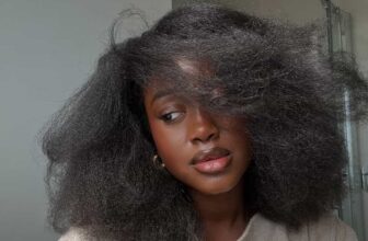 Black African woman wearing her strengthened, curly hair - Fashion Police Nigeria