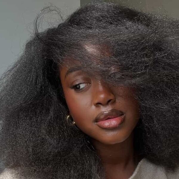Black African woman wearing her strengthened, curly hair - Fashion Police Nigeria