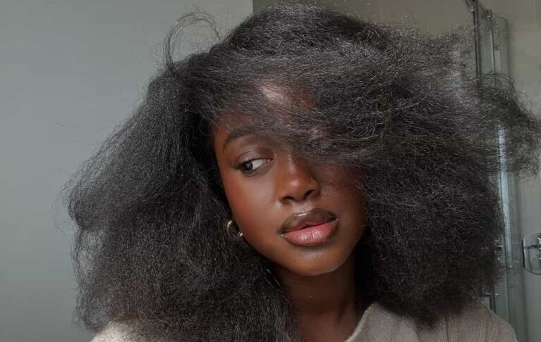 Black African woman wearing her strengthened, curly hair - Fashion Police Nigeria