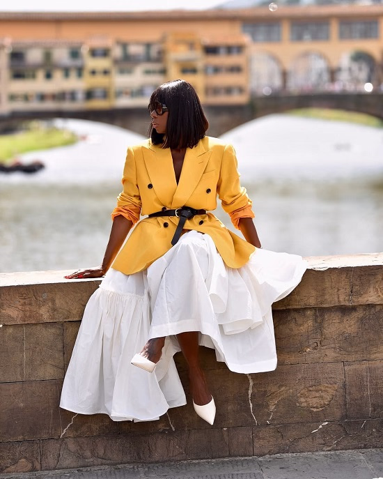 Photo of a Black African American woman wearing a yellow blazer with a skirt - Fashion Police Nigeria