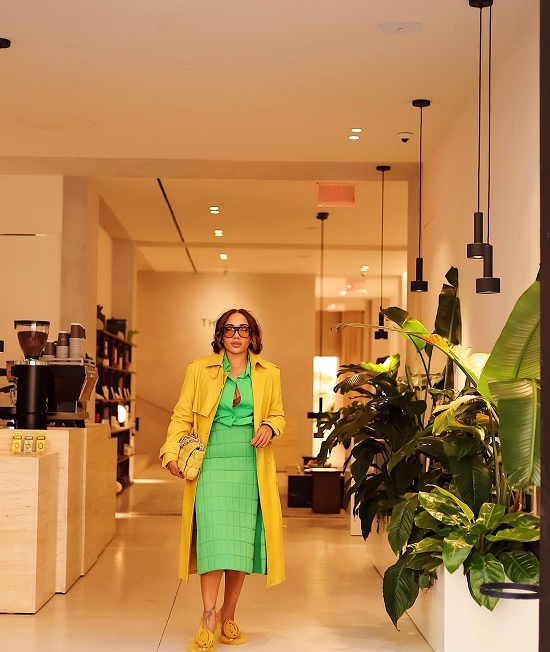 African America woman wearing a green dress under a yellow coat - Fashion Police Nigeria