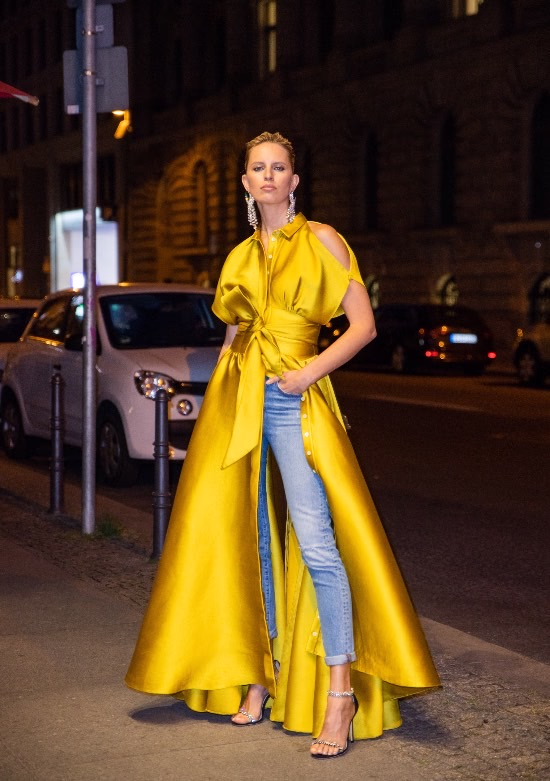 Photo of a woman wearing a yellow dress with blue denim pants - Fashion Police Nigeria