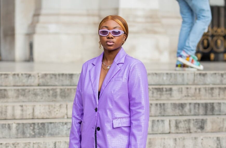 Photo of African American woman wearing purple blazer and accessories for street style during fashion week - Fashion Police Nigeria