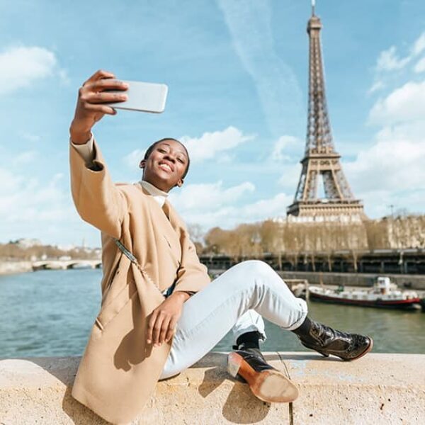 Woman sitting by the river to take vacation selfie - Fashion Police Nigeria