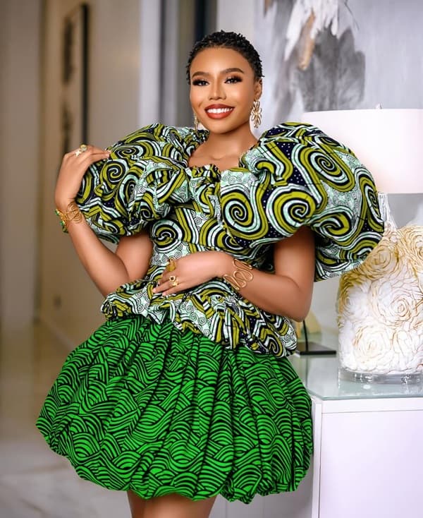 Photo of Nancy Isime wearing a billowing Ankara blouse and bubble-hemmed skirt - Fashion Police Nigeria