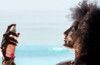 photo of a woman spraying water-based toner on her face