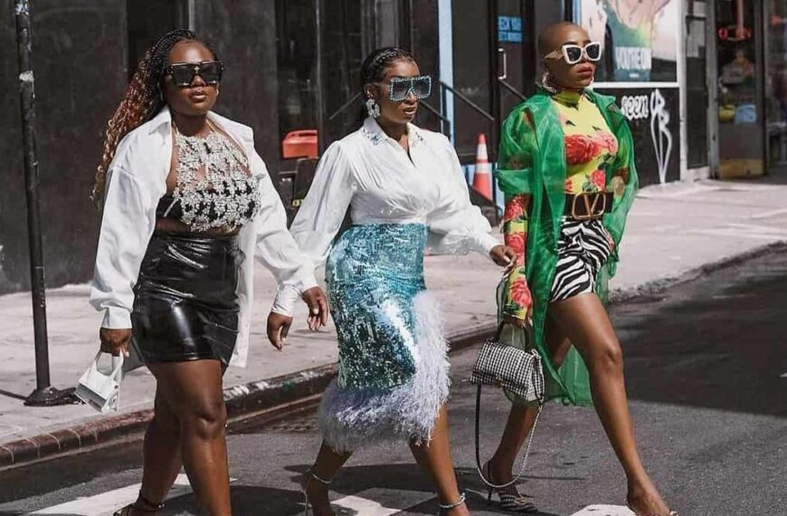 photo of three ladies walking down the street in high fashion outfits