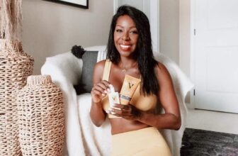 Photo of a black woman holding her sunscreen products
