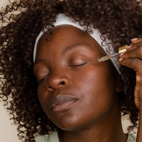 photo of a lady applying skin brightening serum on her face - Fashion Police Nigeria
