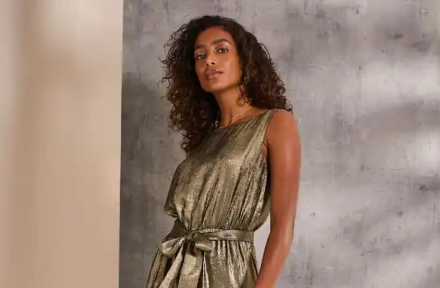 Photo of a model wearing a sparkling, gold metallic jumpsuit - Fashion Police Nigeria