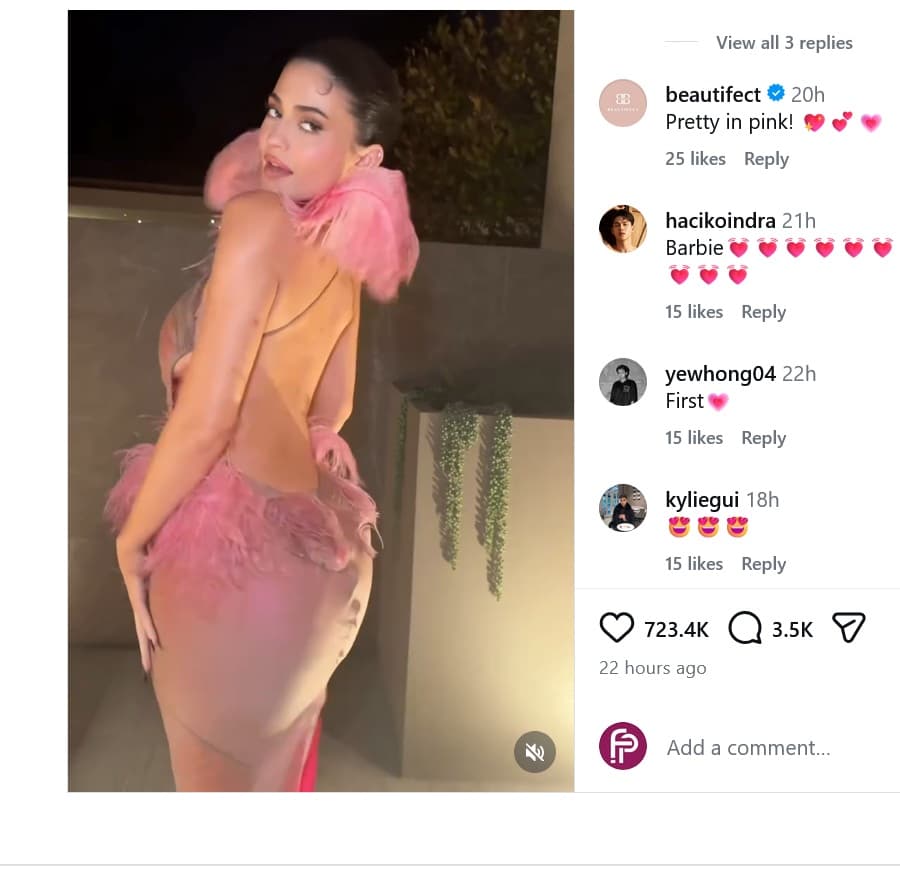 Kylie Jenner wearing a pink party dress with a backless design and feather accent to Kylie Cosmetics annual Christmas party - Fashion Police Nigeria