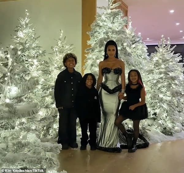Kim Kardashian Raises Eyebrow After Getting New Ears Piercing Kim Kardashian taking photo in front of her massive Christmas Tress with her sons - Fashion Police Nigeria