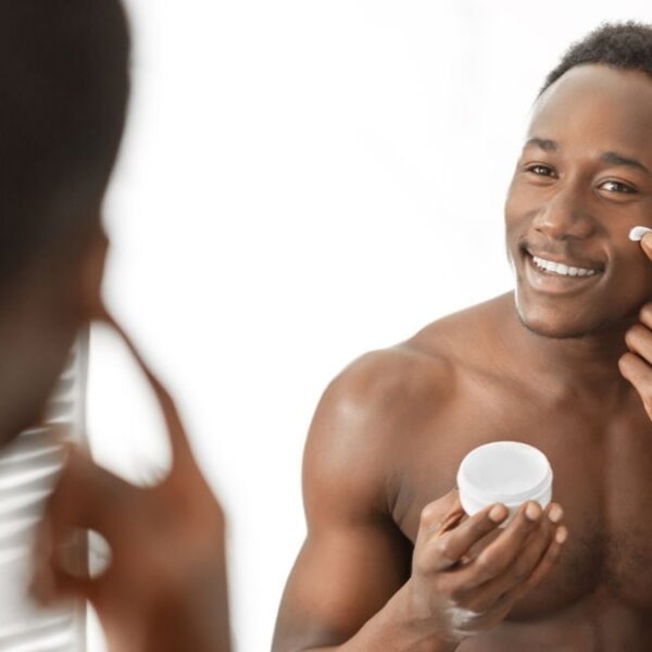 Men in front of the mirror creaming his face - Fashion Police Nigeria