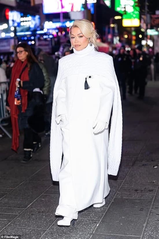 Rita Ora Made Six Glamorous Outfit Changes On New Year's Eve Rita Ora long white coat during the 2025 new year's eve - Fashion Police Nigeria