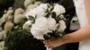 Bride holding a bouquet of white roses - Fashion Police Nigeria
