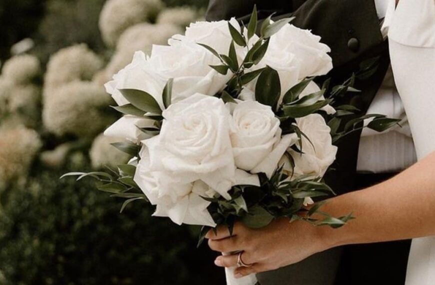 Bride holding a bouquet of white roses - Fashion Police Nigeria