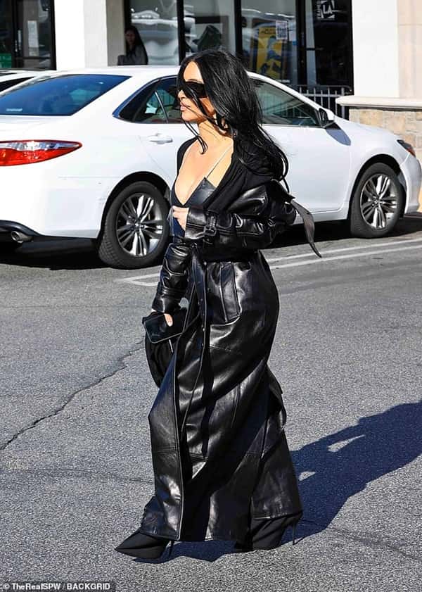 Kim Kardashian is a Bombshell in a Black Leather Coat Kim Kardashian photographed after her trip in Europe with Lewis Hamilton as she wore a long black leather coat - Fashion Police Nigeria