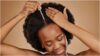 photo of a lady applying hair oil