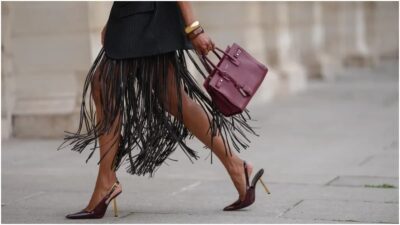 photo of a lady carrying a designer bag