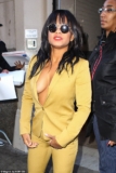 Christiana Milan shows Massive Cleavage in a Mustard-Colored Suit