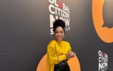 Nomzamo Mbatha Wears Mustard Yellow Blouse and Black Trousers in Spain