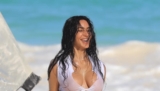 Kim Kardashian Wears a Mismatched White and Blue Bikini Set for a Beach Photoshoot