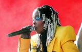 Lauryn Hill’s Coachella Look Includes White Beaded Hair and Balmain Yellow Pantsuit